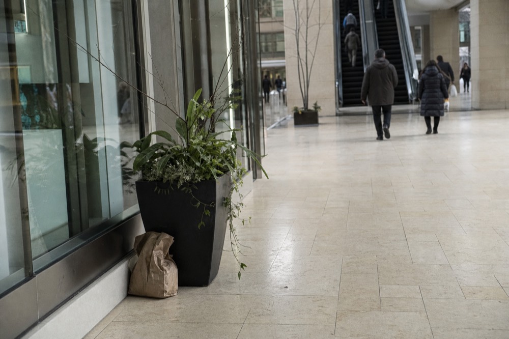 Interior walkway of a large shopping mall leading toward escalators, no text, no logos, no people.